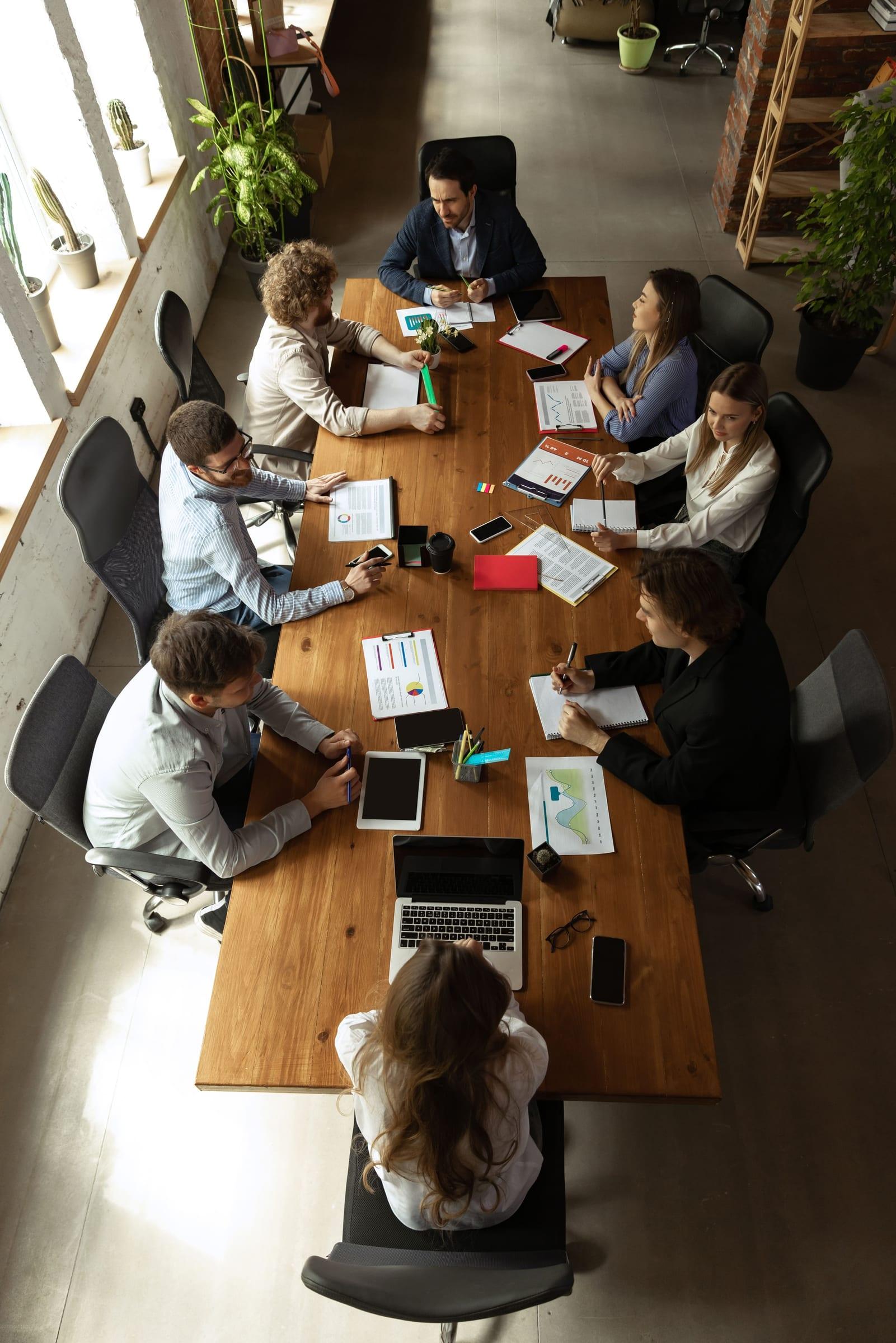 Overhead view of a team meeting around a conference table